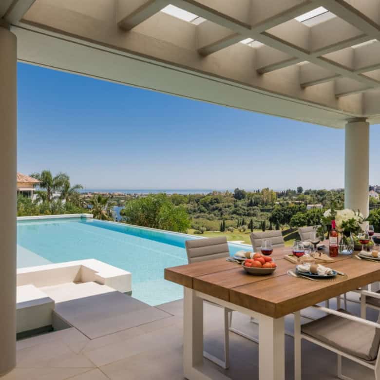 Elegant modern villa with pool and outdoor dining area in Los Flamingos Resort.