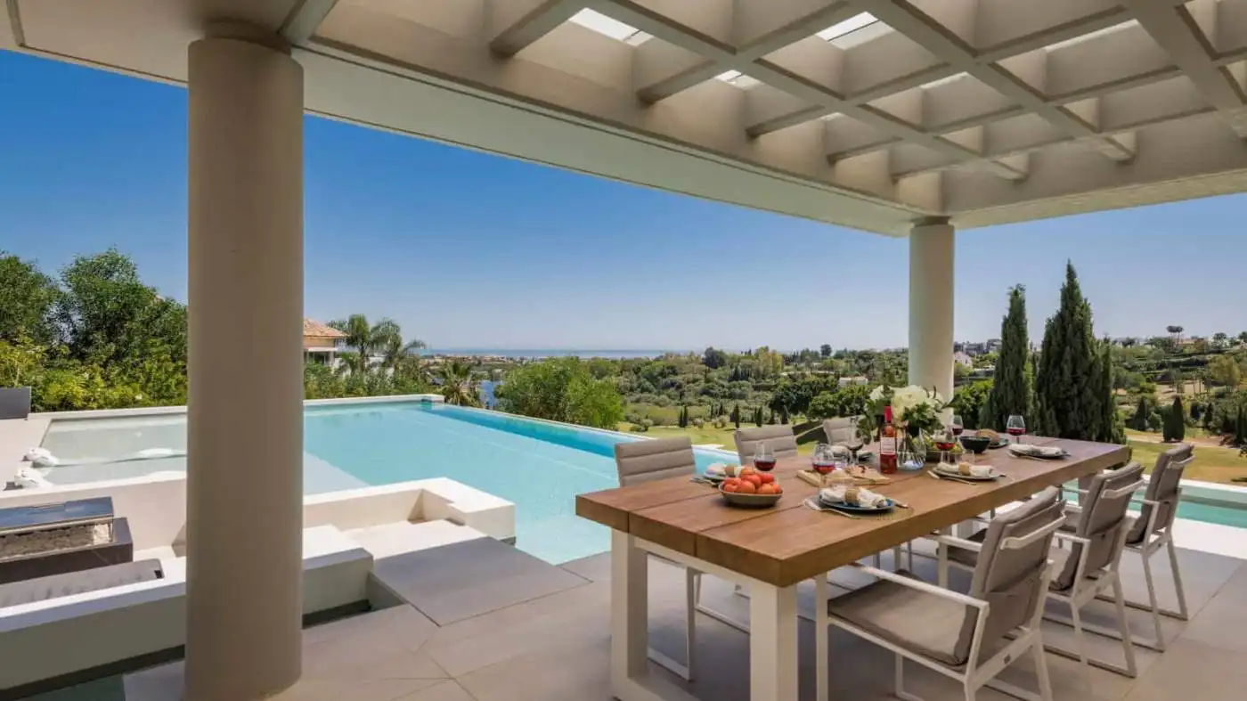 Elegant modern villa with pool and outdoor dining area in Los Flamingos Resort.
