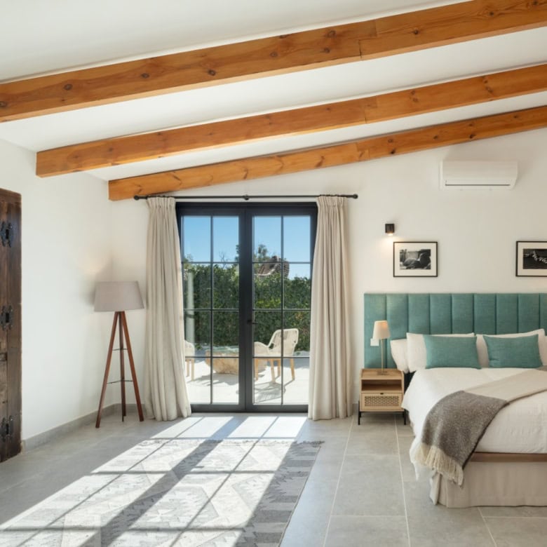 Beautiful bedroom with modern decor and large glass doors.