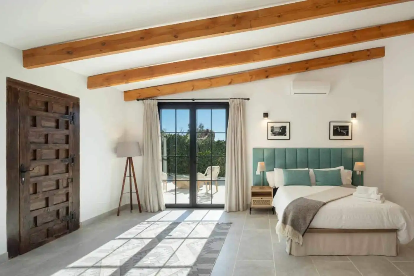 Beautiful bedroom with modern decor and large glass doors.