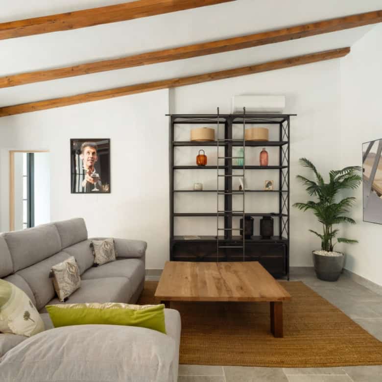 Stylish living room featuring a comfortable sofa, wall-mounted TV, and contemporary decor.