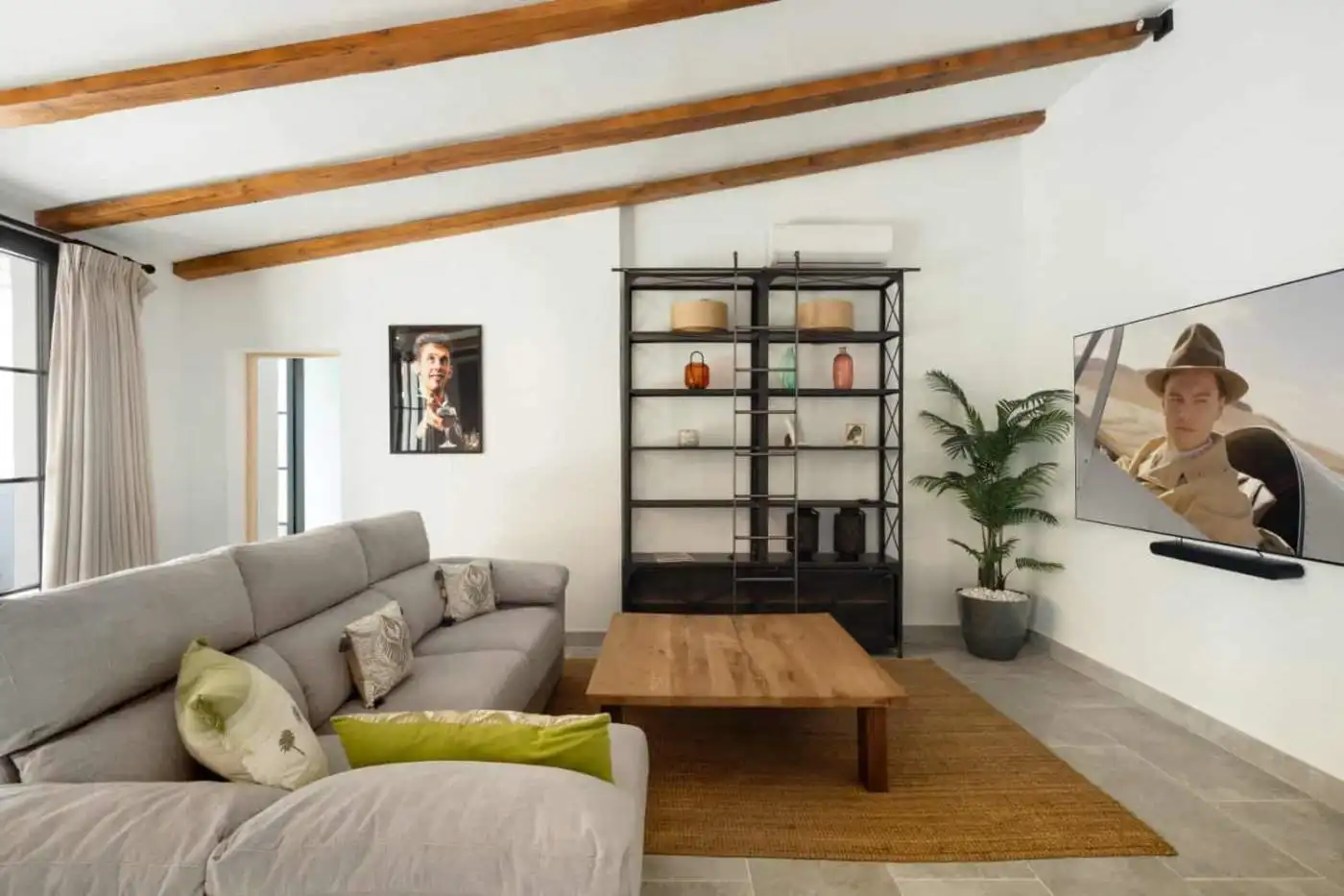 Stylish living room featuring a comfortable sofa, wall-mounted TV, and contemporary decor.