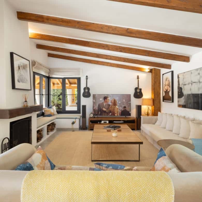 Bright and spacious living room in Casa Teresita with wooden ceiling beams and modern decor.