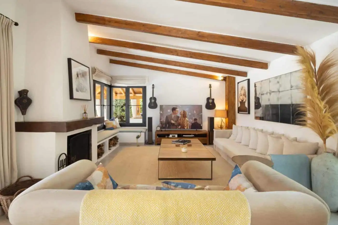 Bright and spacious living room in Casa Teresita with wooden ceiling beams and modern decor.