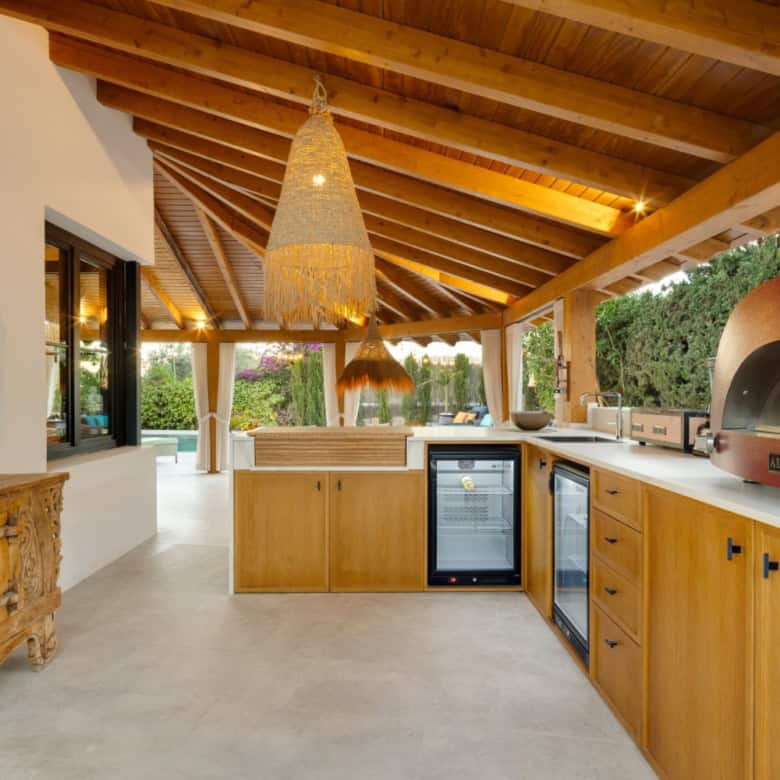 Outdoor kitchen at Casa Teresita with wooden ceiling and contemporary appliances.