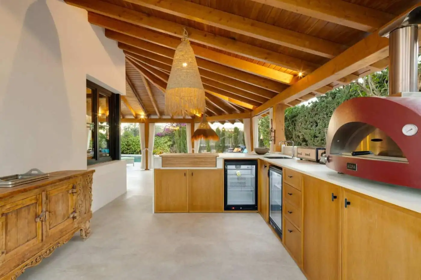 Outdoor kitchen at Casa Teresita with wooden ceiling and contemporary appliances.