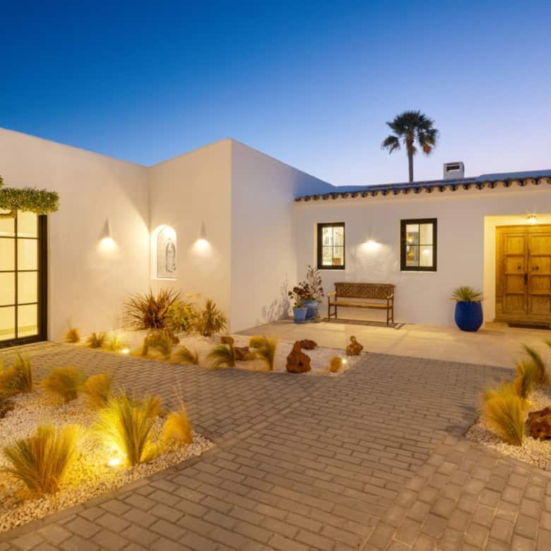 Beautiful exterior view of Casa Teresita with modern architecture and landscaped courtyard at dusk.