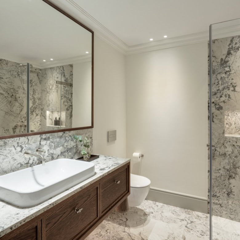 Modern bathroom with marble finishes and elegant fixtures in La Zagaleta villa.