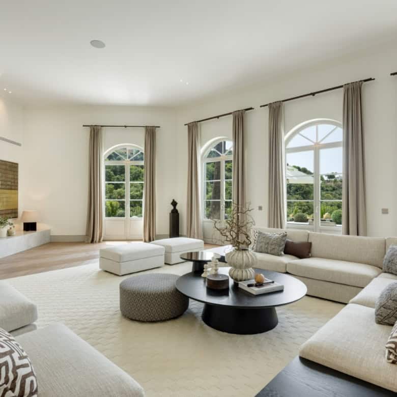 Spacious living area with large arched windows offering scenic views in Villa Liora, La Zagaleta.