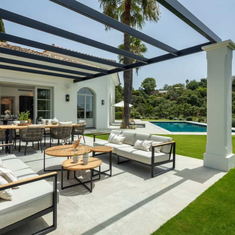 Luxury contemporary outdoor lounge with seating and dining space in La Zagaleta.