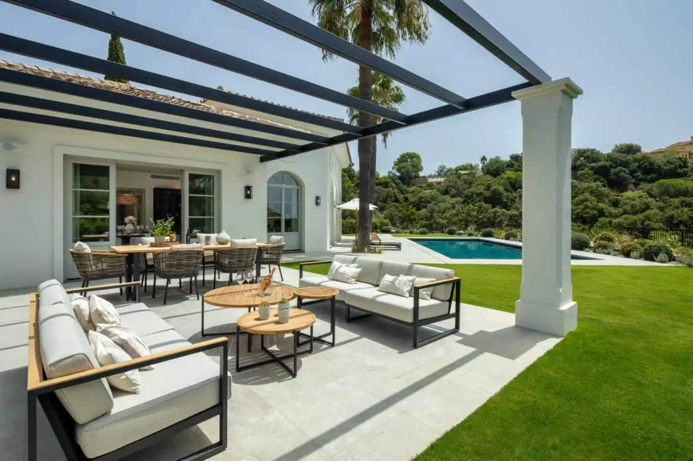 Luxury contemporary outdoor lounge with seating and dining space in La Zagaleta.