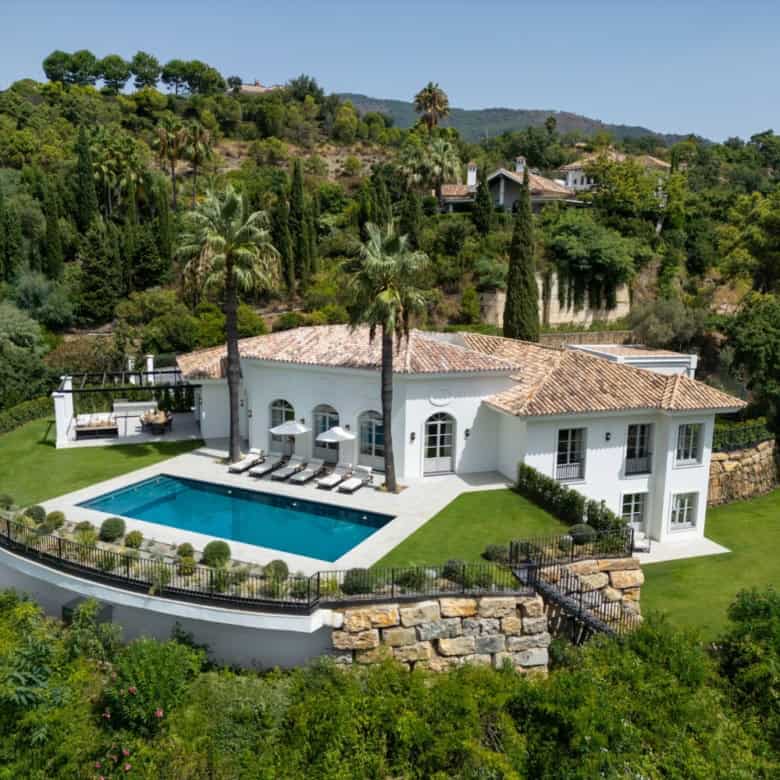 Luxury contemporary villa with private pool in La Zagaleta, surrounded by lush greenery and scenic h.