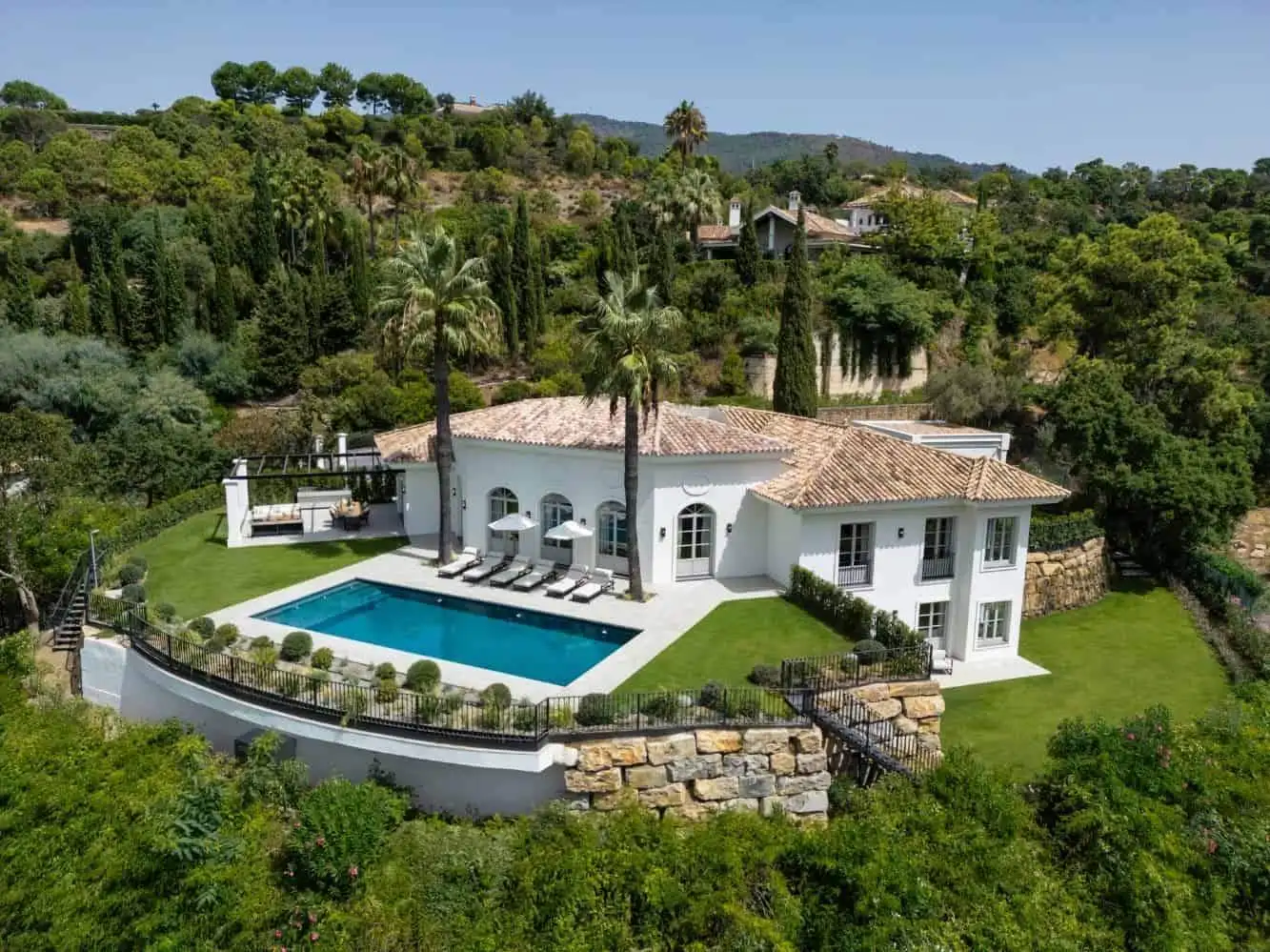 Luxury contemporary villa with private pool in La Zagaleta, surrounded by lush greenery and scenic h.