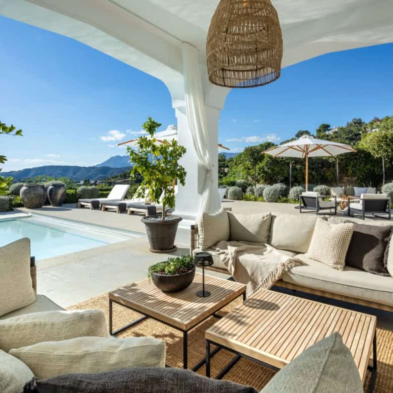 Elegant outdoor lounge with panoramic vistas of Marbella's landscape and mountains.