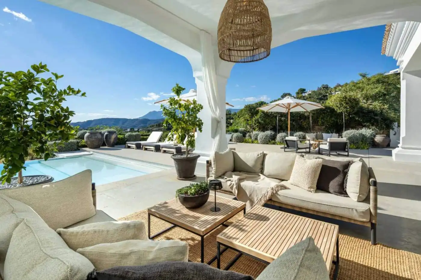 Elegant outdoor lounge with panoramic vistas of Marbella's landscape and mountains.