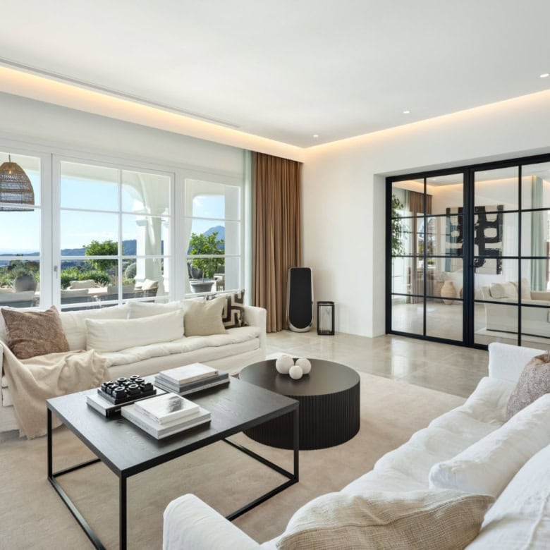 Elegant living room with panoramic views in Marbella mansion.
