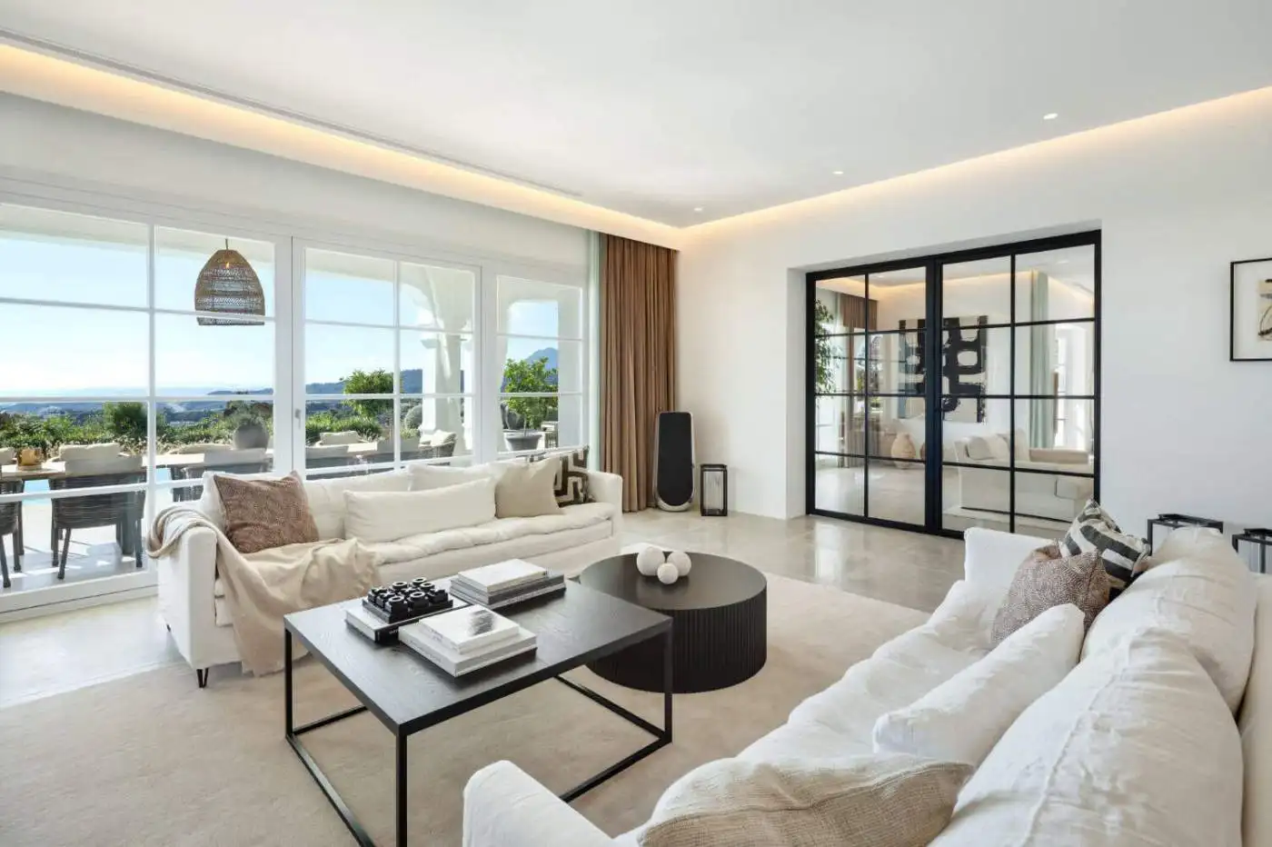 Elegant living room with panoramic views in Marbella mansion.