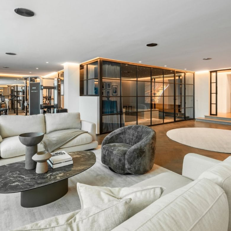 Spacious living room with modern furniture and panoramic views in a luxury mansion in Marbella.