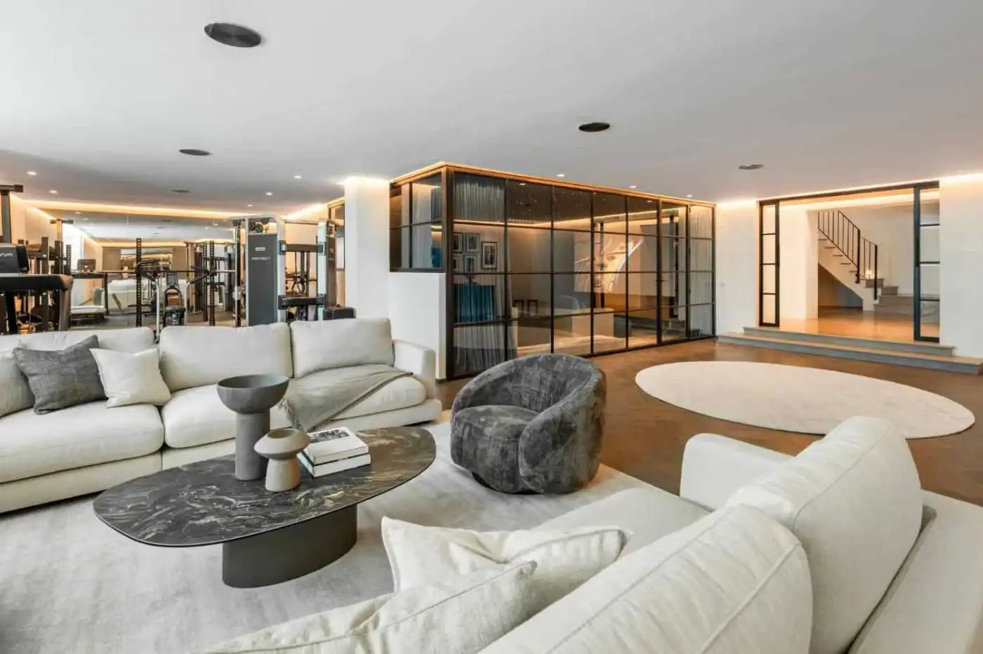 Spacious living room with modern furniture and panoramic views in a luxury mansion in Marbella.
