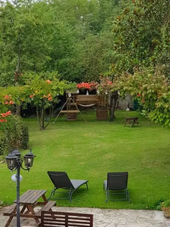Beautiful garden featuring lush greenery and stone houses in La Celle-sur-Morin. Perfect for relaxin.
