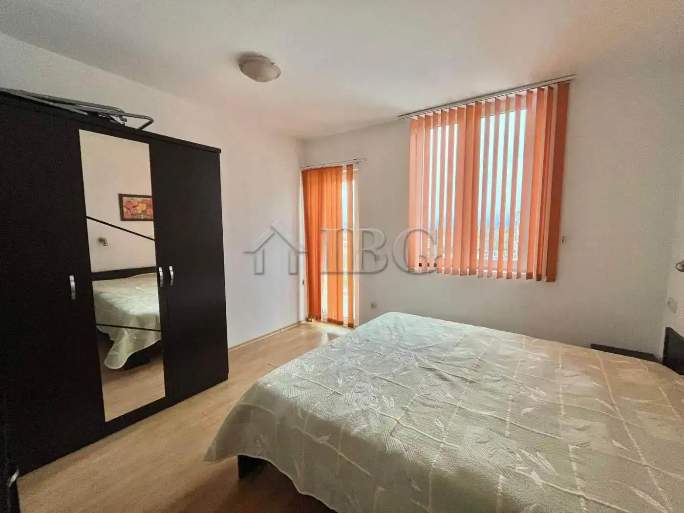 Spacious bedroom with large windows and vertical blinds in a luxury villa in Varzi, Italy.