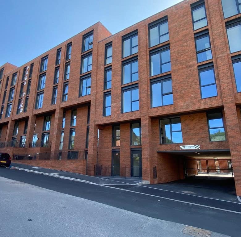 Apartment building with modern brick facade in Birmingham, UK.
