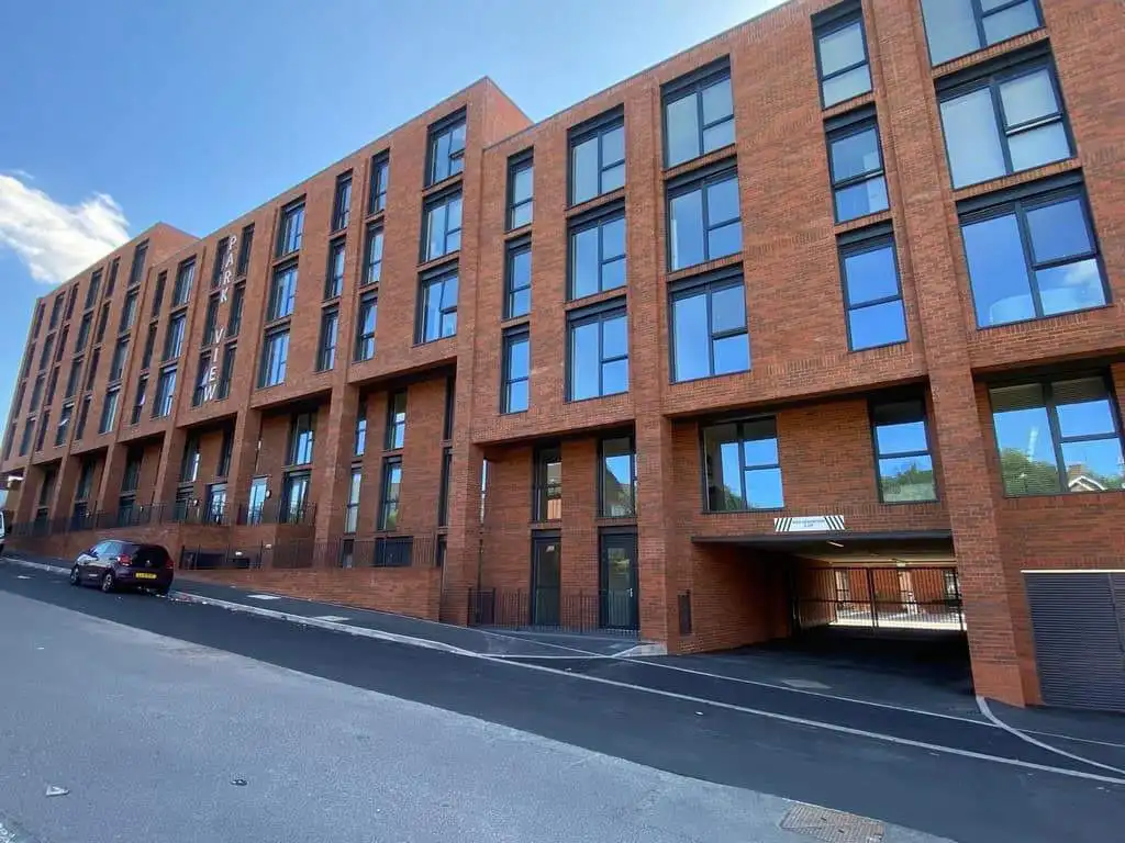 Apartment building with modern brick facade in Birmingham, UK.