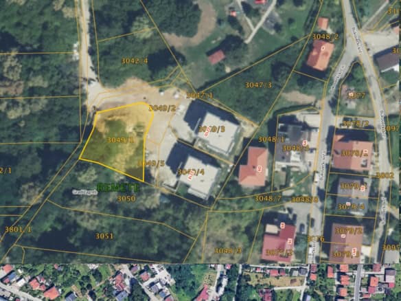 Aerial view of a development land plot for sale in Zagreb, Croatia, surrounded by greenery and resid.