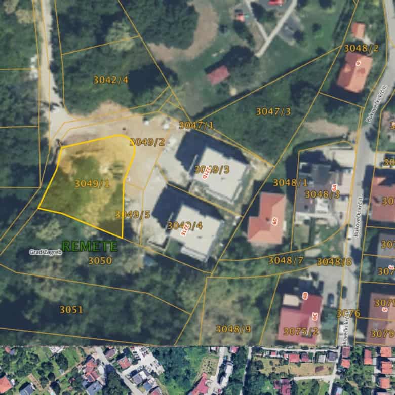 Aerial view of a development land plot for sale in Zagreb, Croatia, surrounded by greenery and resid.