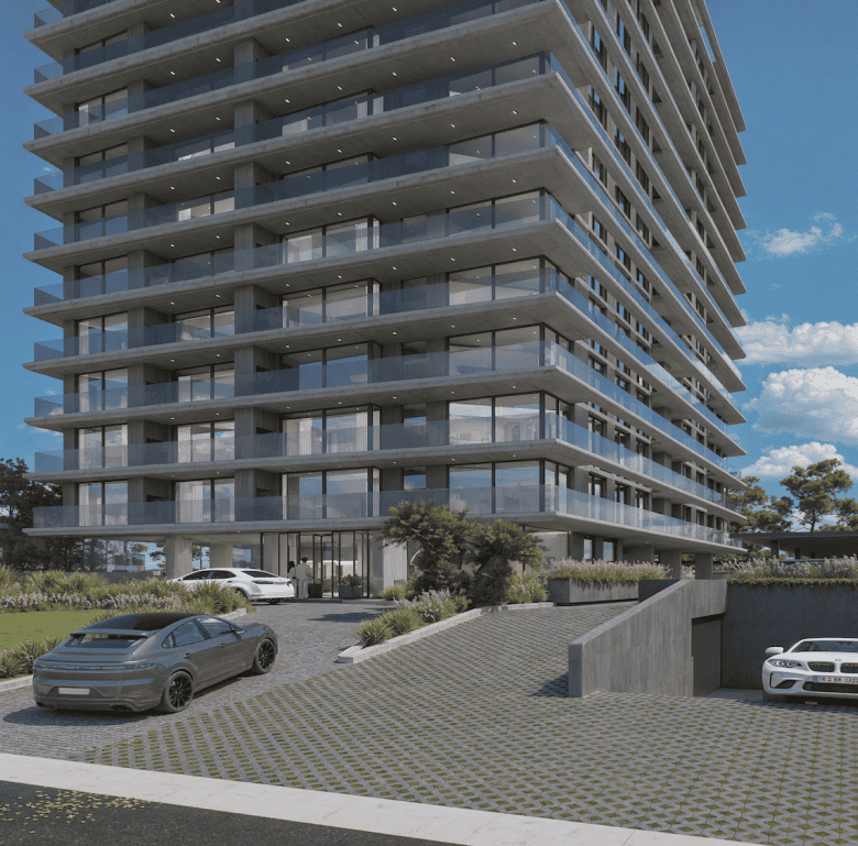 High-rise apartment building in Punta del Este, Uruguay, with parking area and landscaped surroundin.