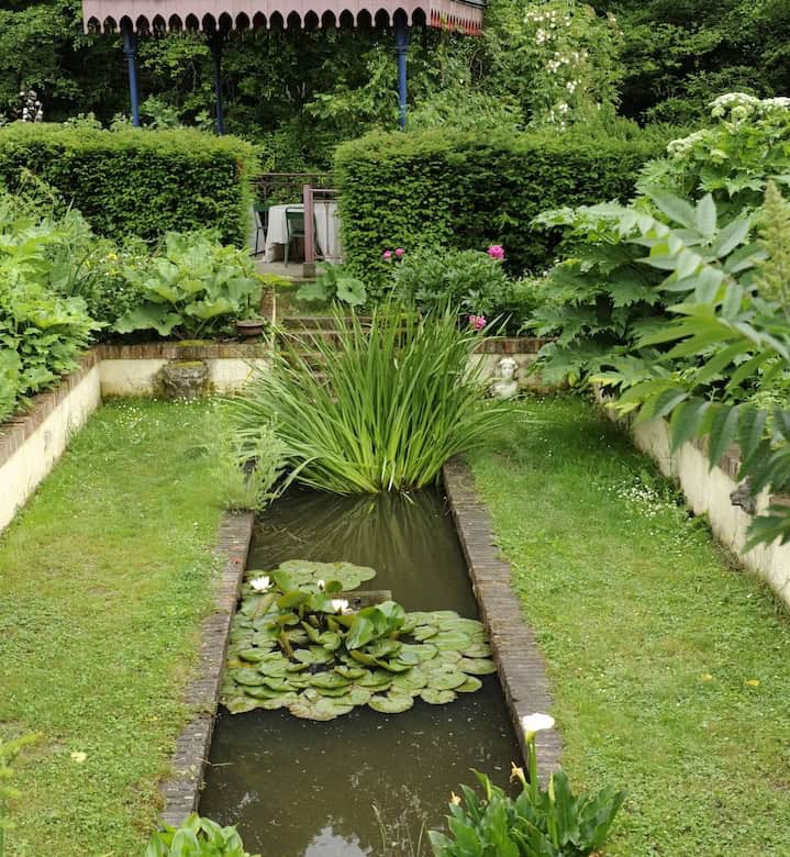 Beautiful garden with pond and gazebo in Thiers, France.