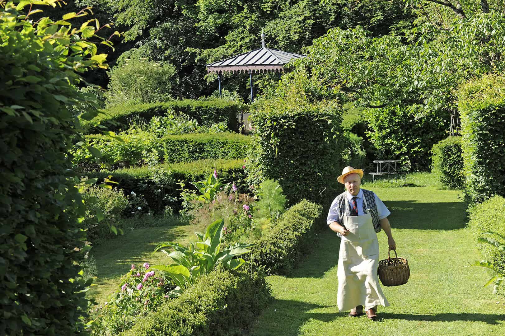 Château de la Chassaigne Garden View Château de la Chassaigne garden with lush greenery and a person enjoying the serene landscape in Thi.