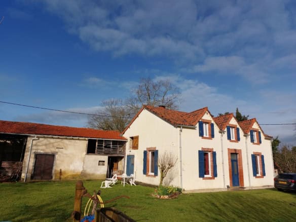 Beautiful farmhouse with traditional architecture in Madiran, France, featuring a white facade and b.
