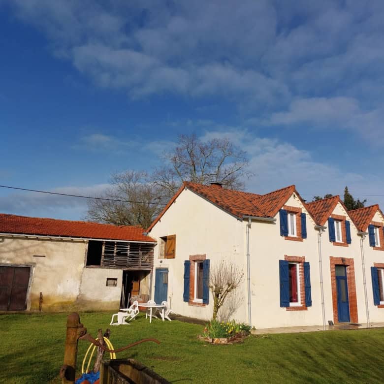 Beautiful farmhouse with traditional architecture in Madiran, France, featuring a white facade and b.