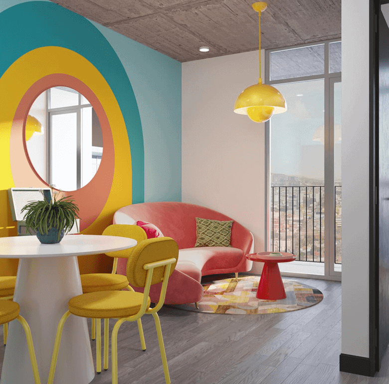 Bright interior featuring a pink sofa, yellow chairs, and playful wall design in Barrio Escalante, S.