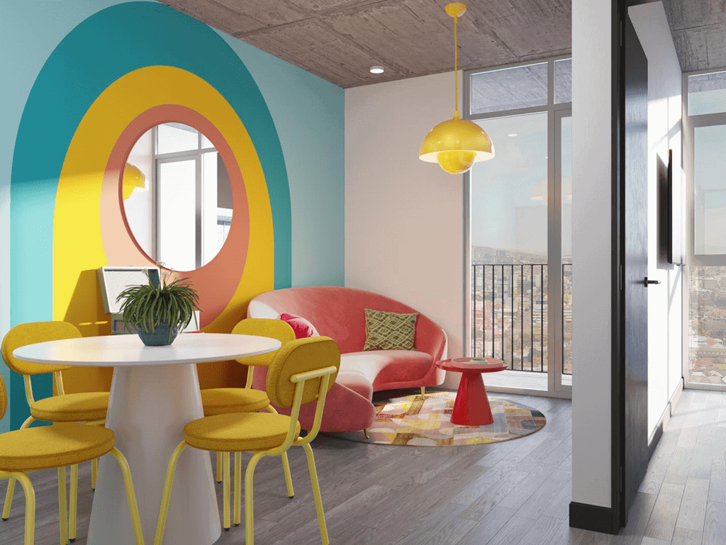 Bright interior featuring a pink sofa, yellow chairs, and playful wall design in Barrio Escalante, S.