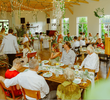 Indoor event at Valmoniras Commercial Farm in Kekava, Latvia, with guests dining and socializing.