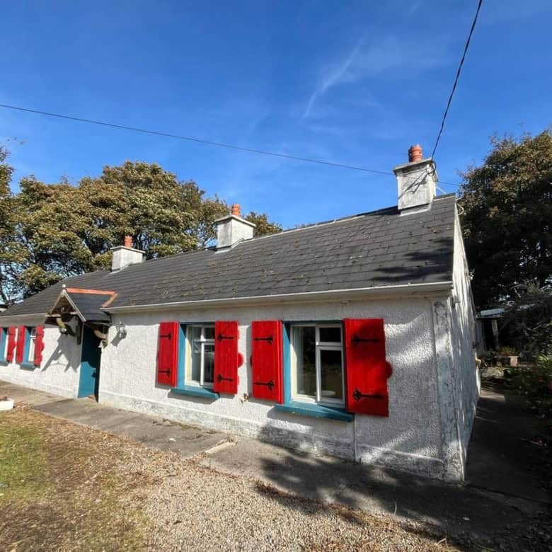Irish cottage for sale in Farranmacfarrell, Ballina, County Sligo, featuring charming red shutters a.