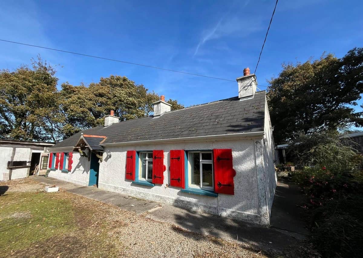 Irish cottage for sale in Farranmacfarrell, Ballina, County Sligo, featuring charming red shutters a.
