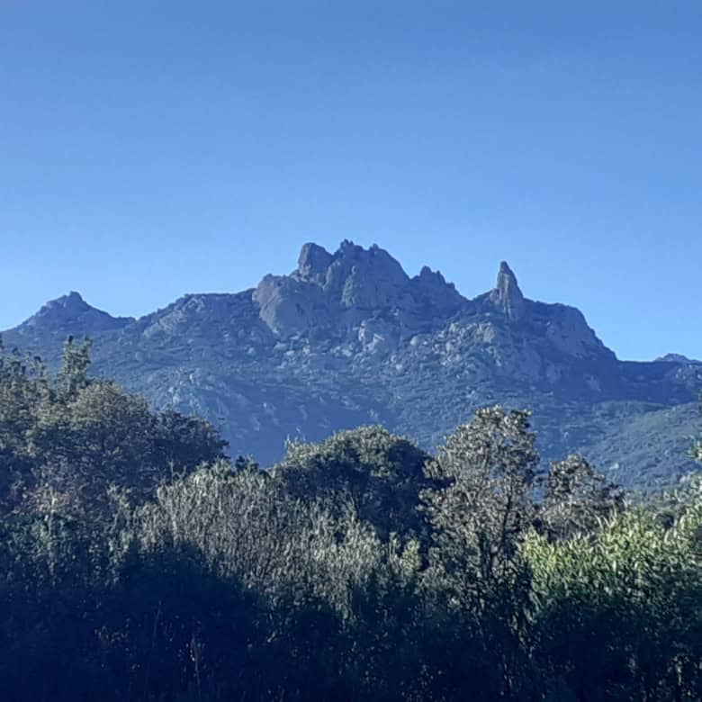 Mountain view of rugged peaks in Sardinia, Italy, ideal for renovation of a 3-bed apartment.