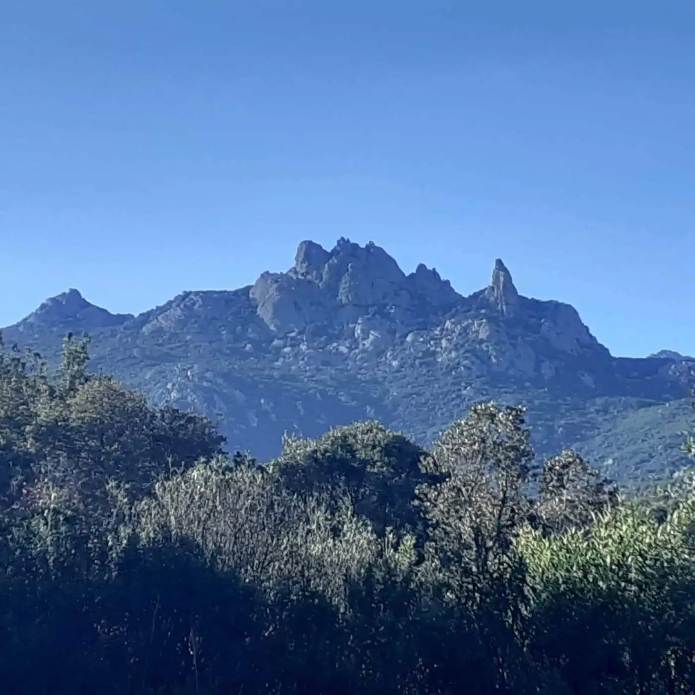 Mountain view of rugged peaks in Sardinia, Italy, ideal for renovation of a 3-bed apartment.
