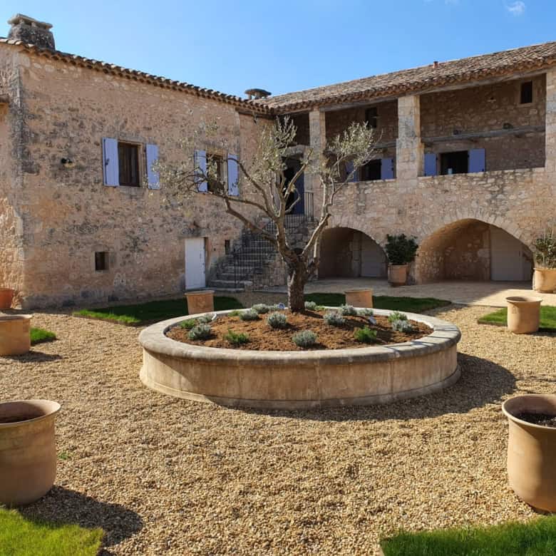 Elegant estate with a central courtyard and olive trees in Goudargues, France.
