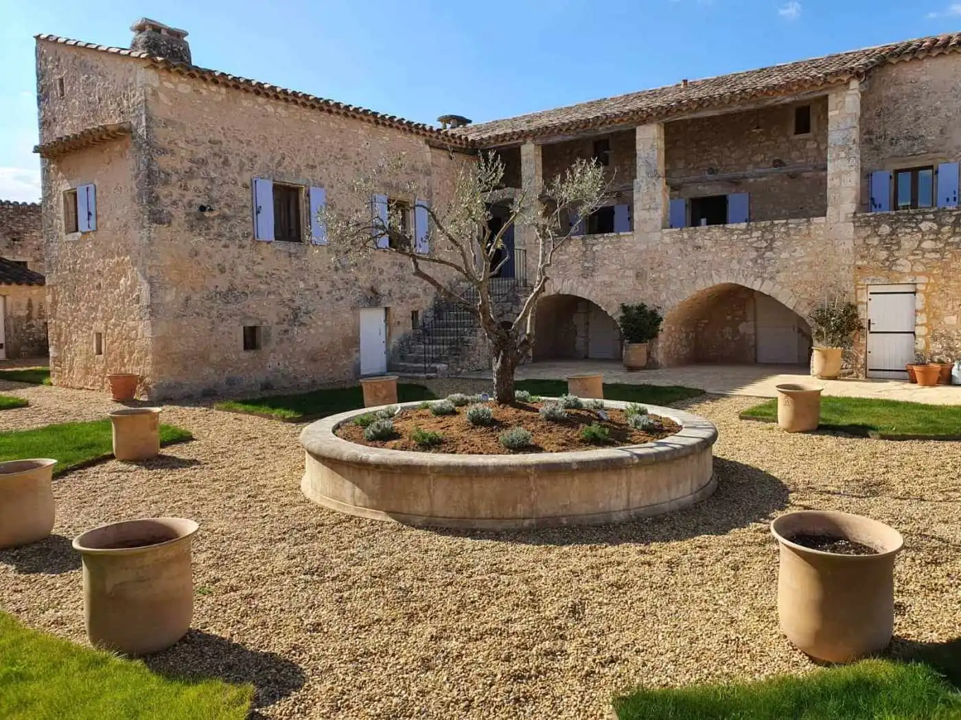 Elegant estate with a central courtyard and olive trees in Goudargues, France.