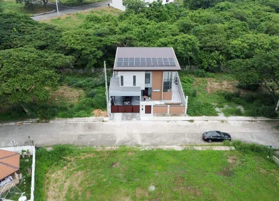 Modern Villa with Solar Panels in Dasmarinas Philippines Contemporary villa with solar panels located in a lush green area in Dasmarinas, Philippines.