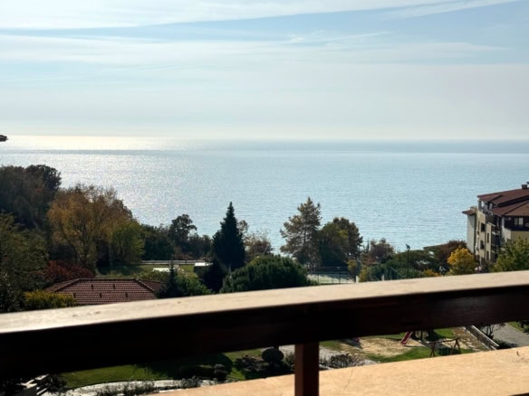Panoramic view of green landscape and distant buildings from Sveti Vlas apartment.