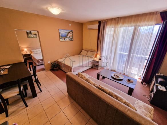 Spacious living room with balcony overlooking Aheloy Beachfront. Modern furnishings and bright natur.