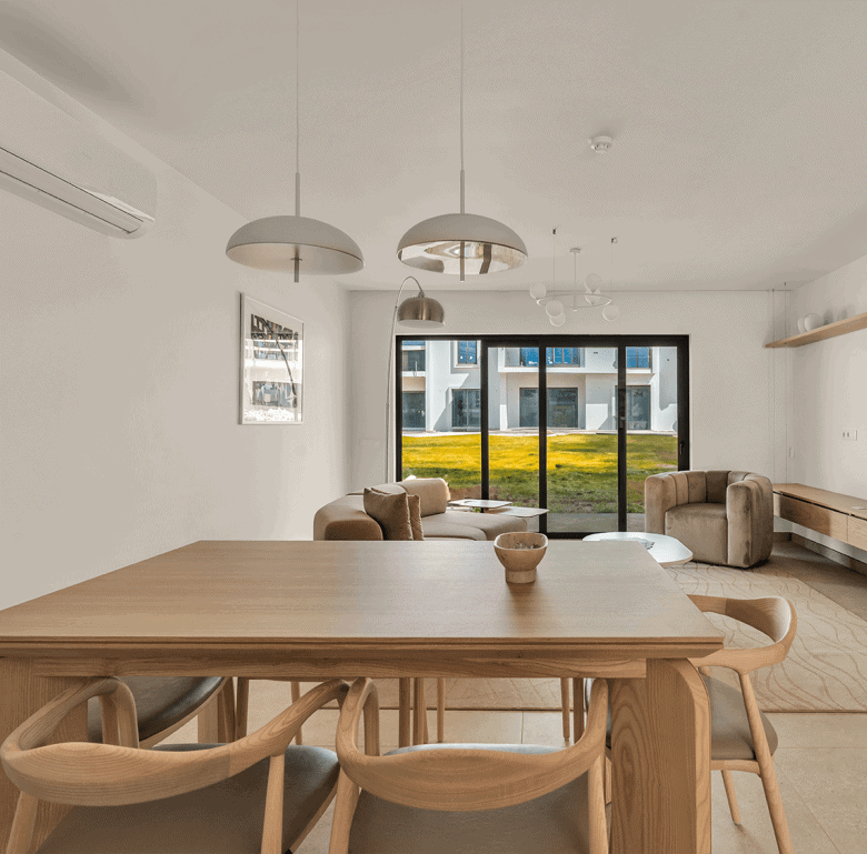 Bright interior of a modern Algarve apartment featuring a spacious living area and large window with.