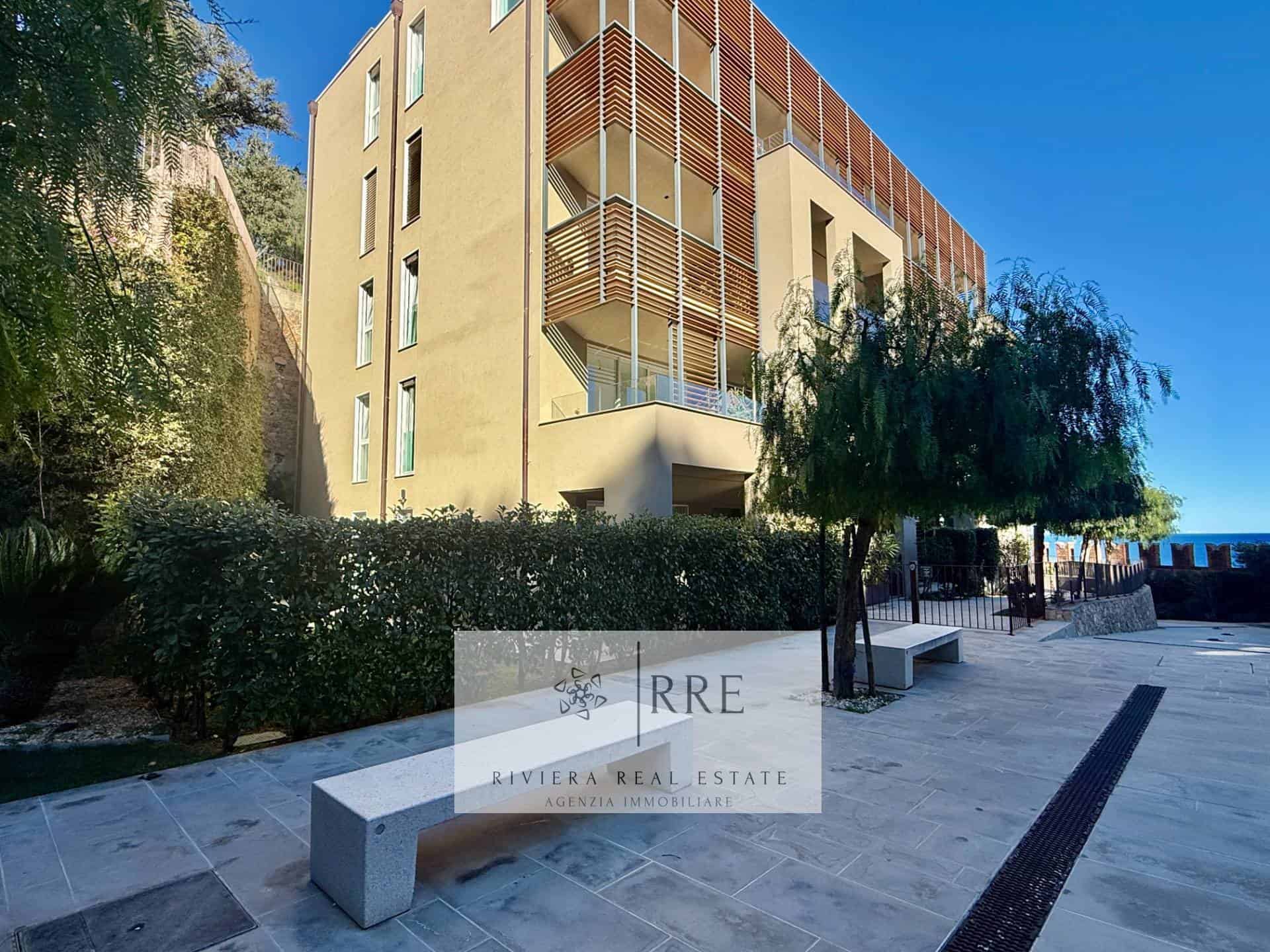 Modern apartment building with balconies and landscaped surroundings.