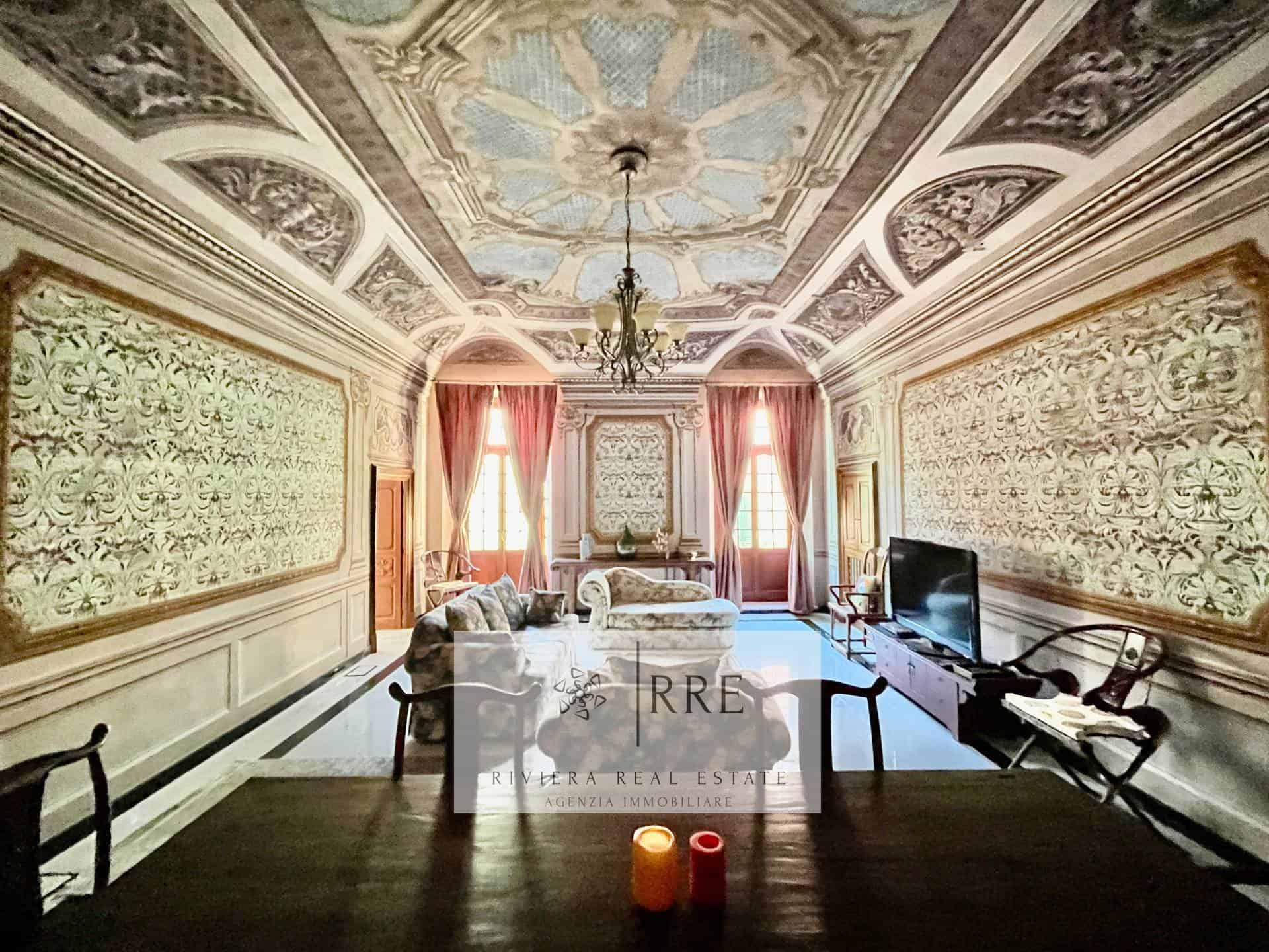Elegant historic living room with ornate ceiling and classic decor.