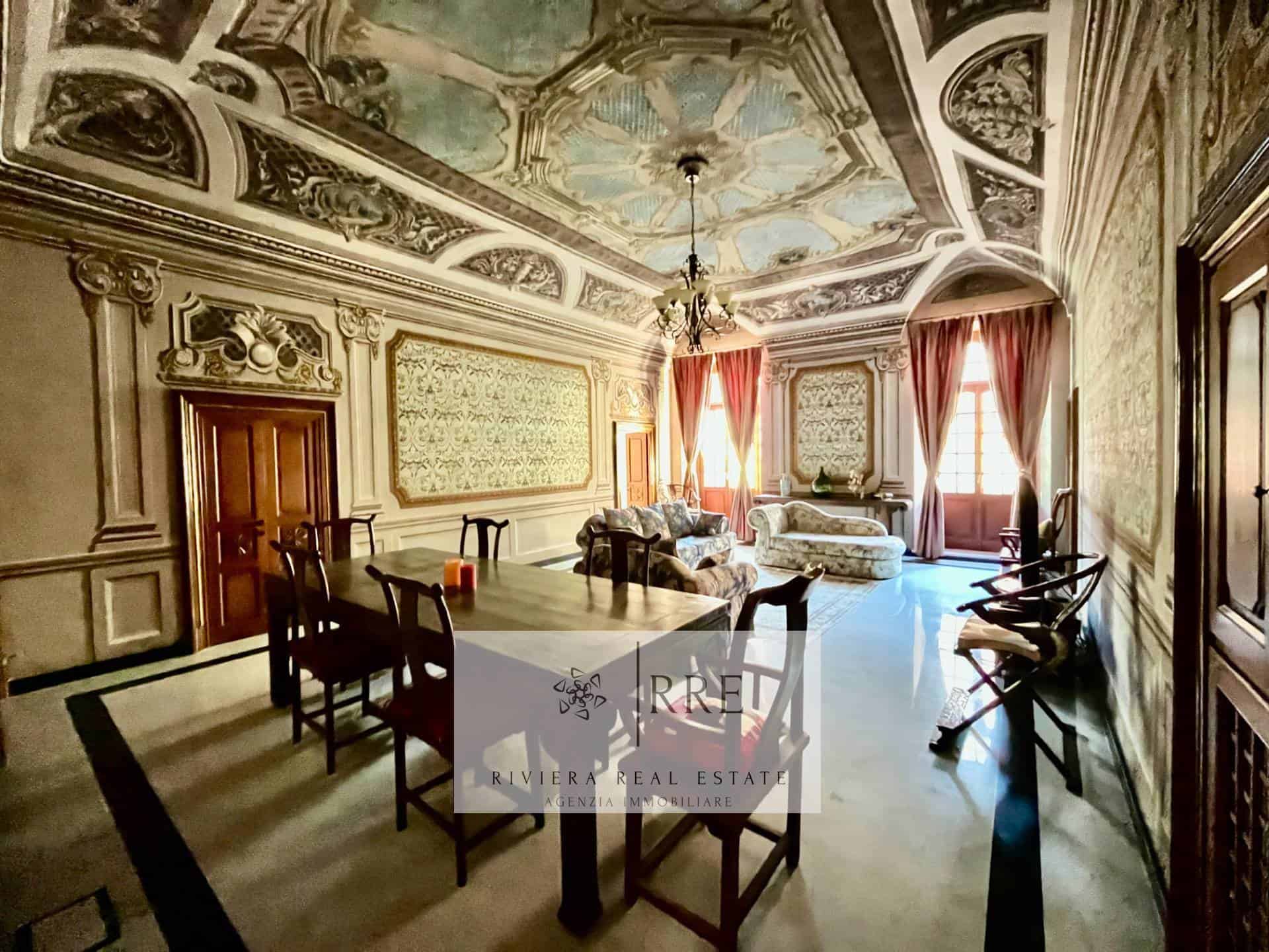 Elegant historic living room with ornate ceiling and classic decor, featuring vintage furniture and.